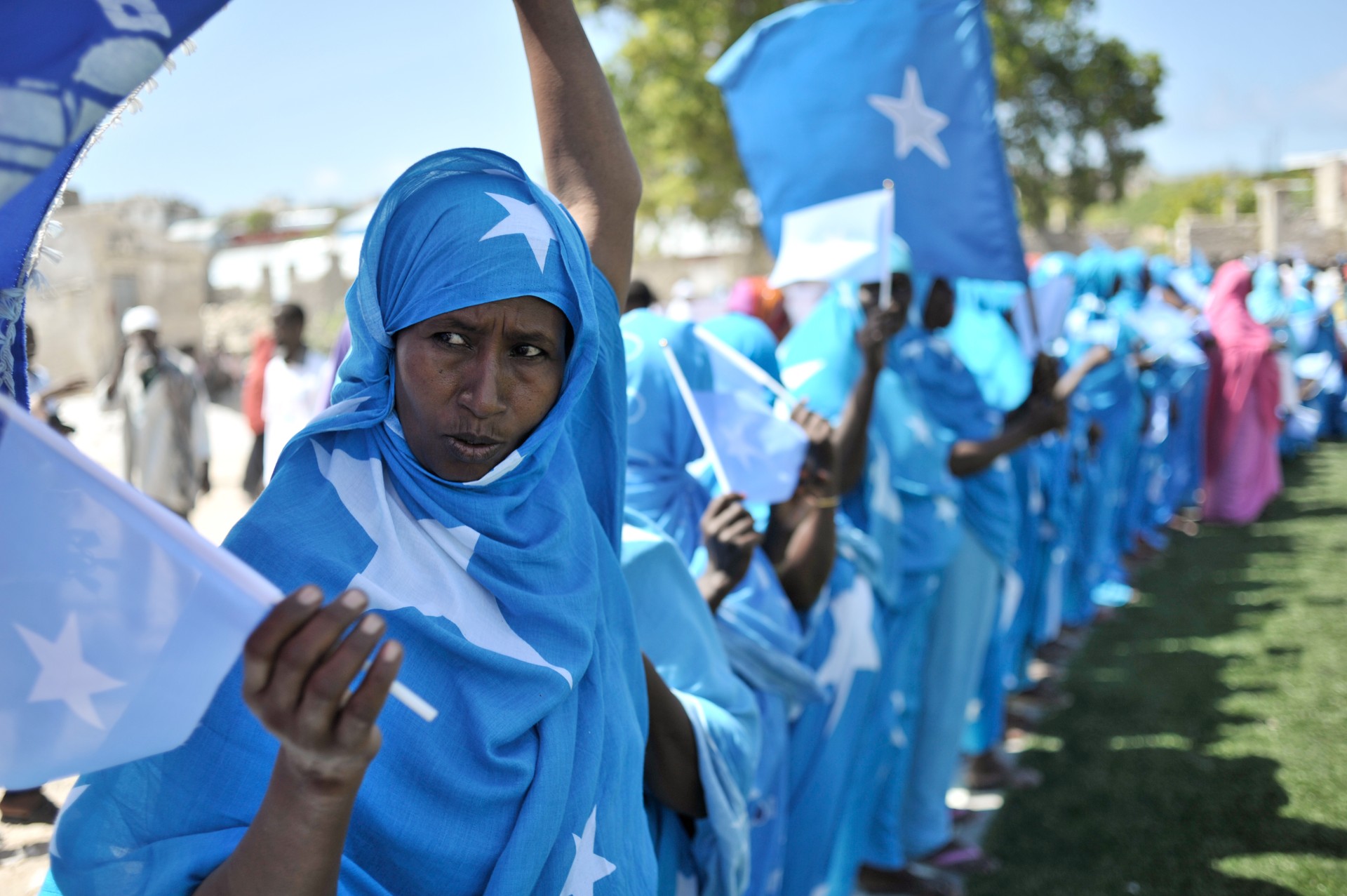 Women adorned in Somali flags celebrate Somalia's Independence Day at Konis stadium, in Mogadishu, Somali, July 1, 2013. (UN Photo)